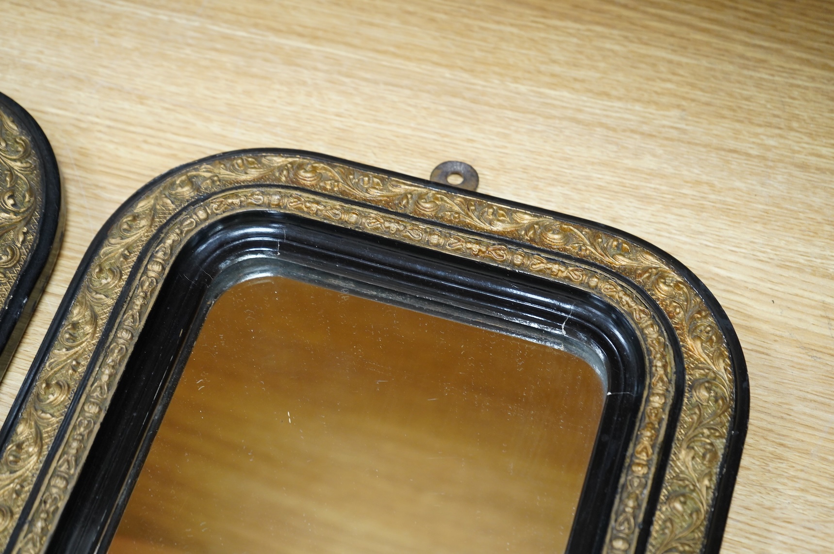 A pair of 19th century French ebonised and gilt wall mirrors, 32 x 27cm